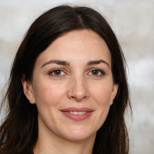 Joyful white adult female with long  brown hair and brown eyes