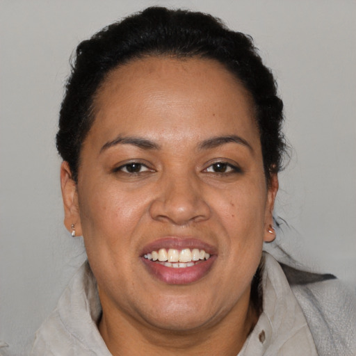 Joyful black adult female with short  brown hair and brown eyes