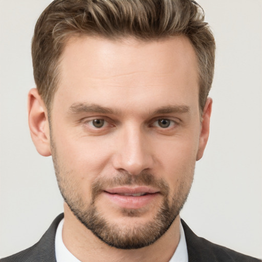 Joyful white young-adult male with short  brown hair and grey eyes