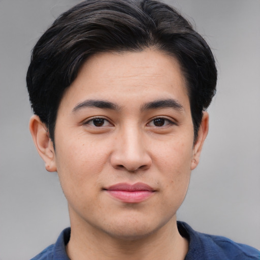 Joyful asian young-adult male with short  black hair and brown eyes