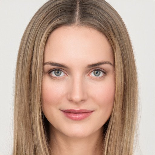 Joyful white young-adult female with long  brown hair and green eyes