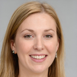 Joyful white young-adult female with long  brown hair and green eyes