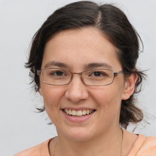 Joyful white adult female with medium  brown hair and brown eyes