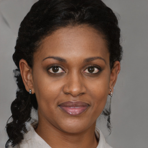 Joyful black young-adult female with short  brown hair and brown eyes