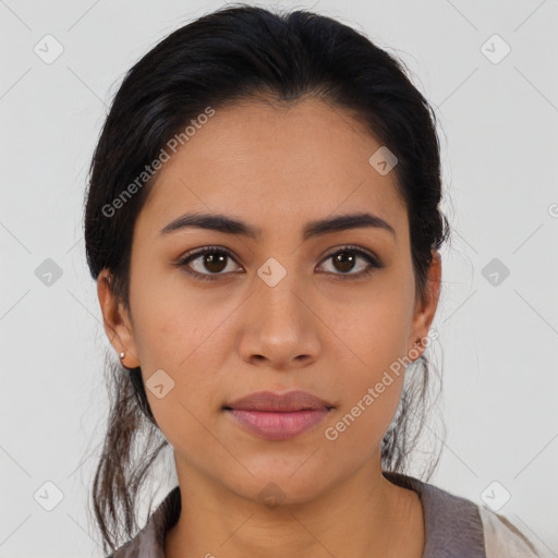 Joyful latino young-adult female with medium  brown hair and brown eyes