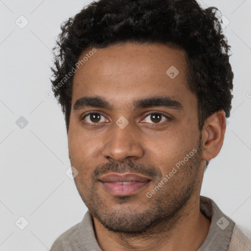 Joyful black young-adult male with short  brown hair and brown eyes