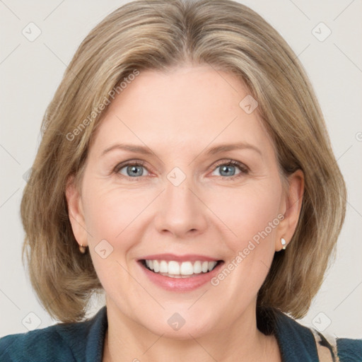 Joyful white adult female with medium  brown hair and blue eyes