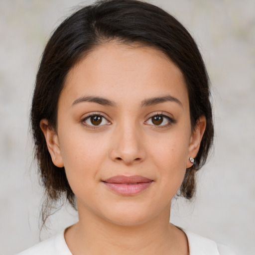 Joyful white young-adult female with medium  brown hair and brown eyes