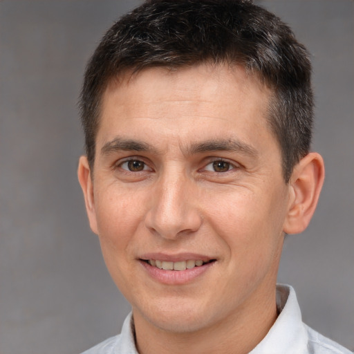 Joyful white adult male with short  brown hair and brown eyes