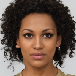 Joyful black young-adult female with medium  brown hair and brown eyes