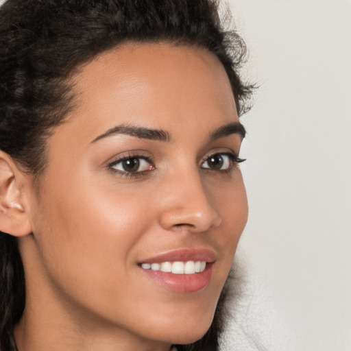 Joyful latino young-adult female with long  brown hair and brown eyes