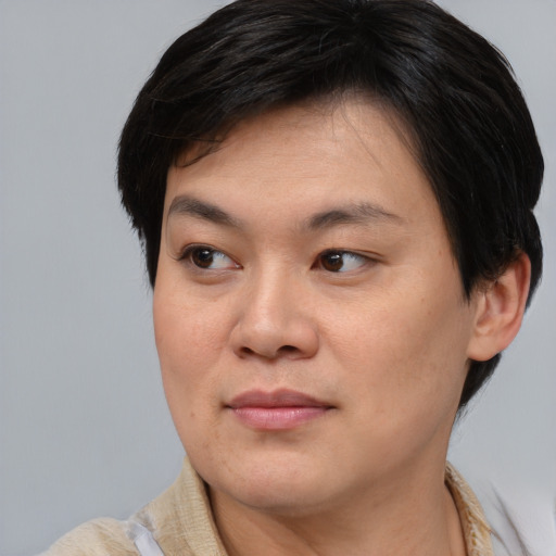 Joyful asian young-adult female with short  brown hair and brown eyes