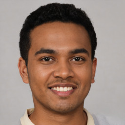 Joyful latino young-adult male with short  black hair and brown eyes