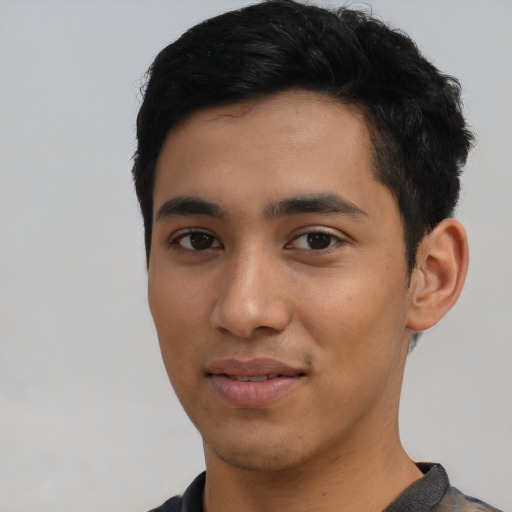 Joyful asian young-adult male with short  black hair and brown eyes