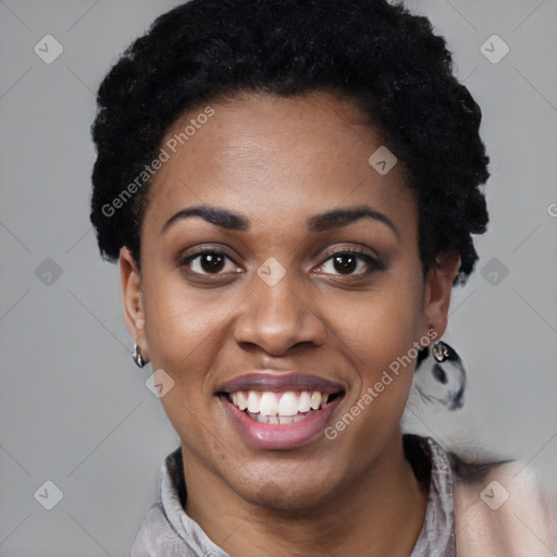 Joyful black young-adult female with short  black hair and brown eyes