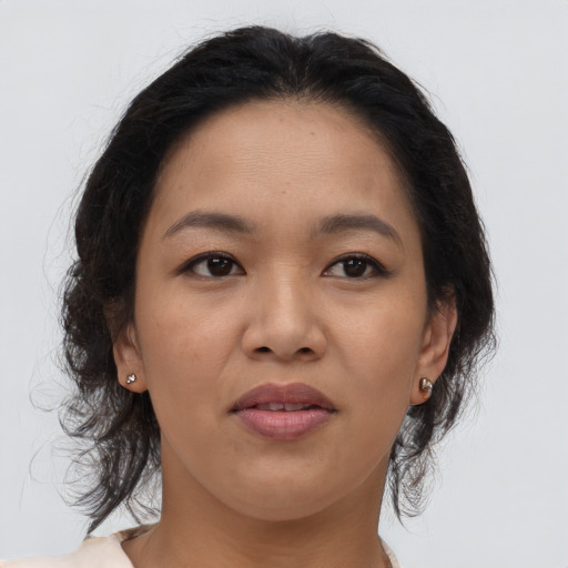 Joyful asian young-adult female with medium  brown hair and brown eyes