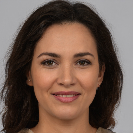 Joyful white young-adult female with long  brown hair and brown eyes