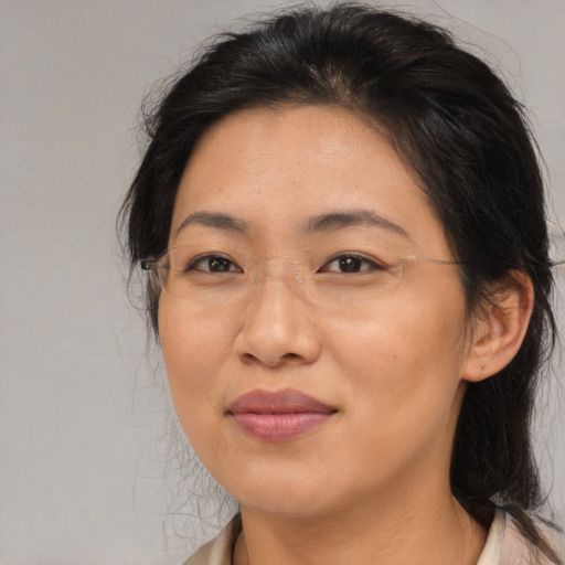 Joyful asian adult female with medium  brown hair and brown eyes
