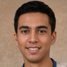 Joyful white young-adult male with short  black hair and brown eyes