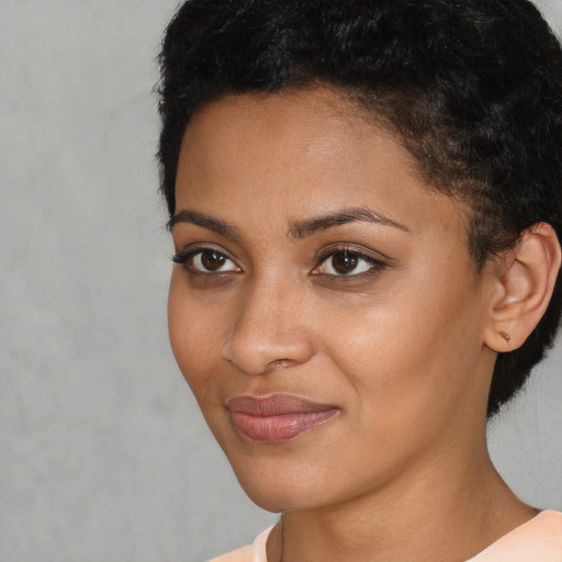 Joyful latino young-adult female with short  black hair and brown eyes