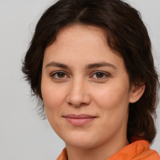 Joyful white young-adult female with medium  brown hair and brown eyes