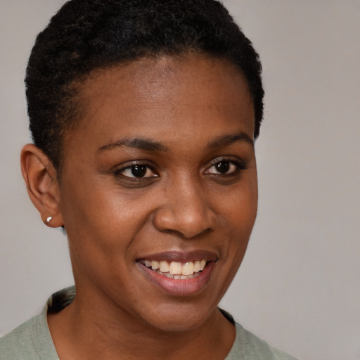 Joyful black young-adult female with short  brown hair and brown eyes