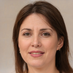 Joyful white adult female with long  brown hair and brown eyes