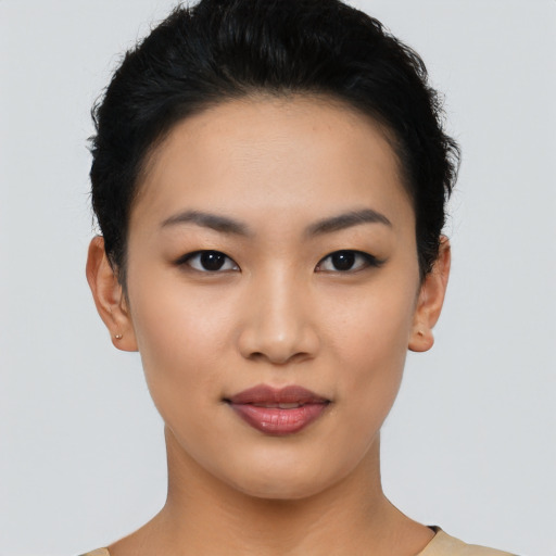 Joyful asian young-adult female with short  black hair and brown eyes