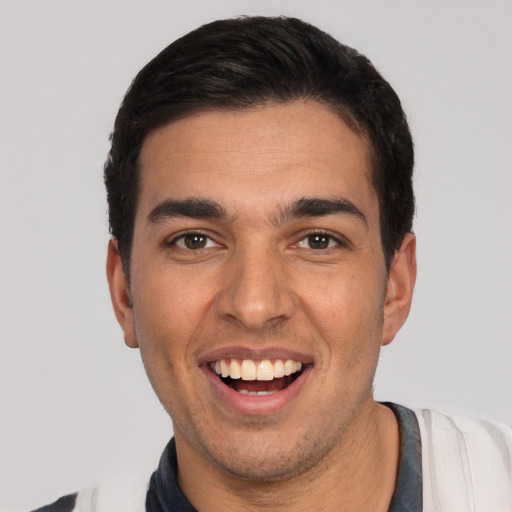 Joyful white young-adult male with short  black hair and brown eyes