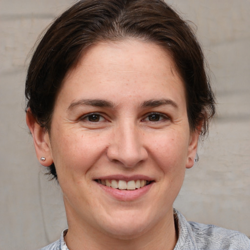 Joyful white adult female with short  brown hair and brown eyes