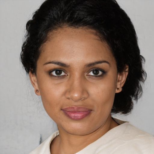 Joyful black young-adult female with medium  brown hair and brown eyes