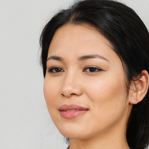 Joyful asian young-adult female with long  brown hair and brown eyes