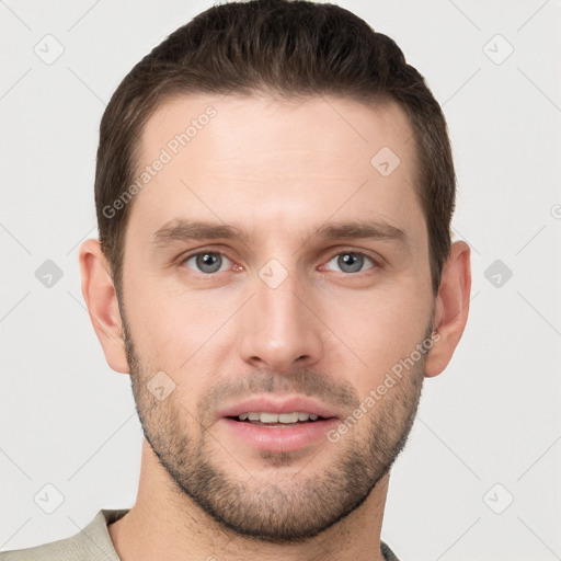 Joyful white young-adult male with short  brown hair and grey eyes