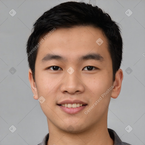 Joyful asian young-adult male with short  black hair and brown eyes