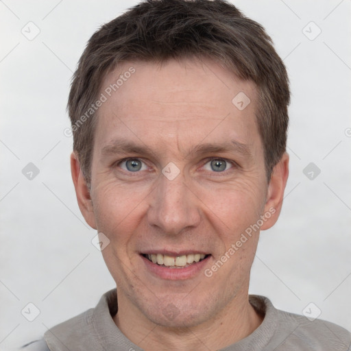 Joyful white adult male with short  brown hair and grey eyes