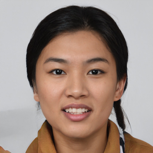 Joyful asian young-adult female with medium  brown hair and brown eyes