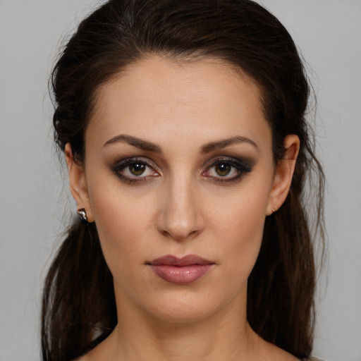 Joyful white young-adult female with long  brown hair and brown eyes