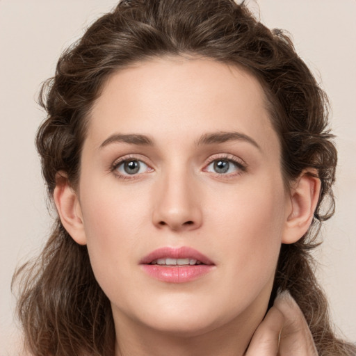 Joyful white young-adult female with long  brown hair and green eyes