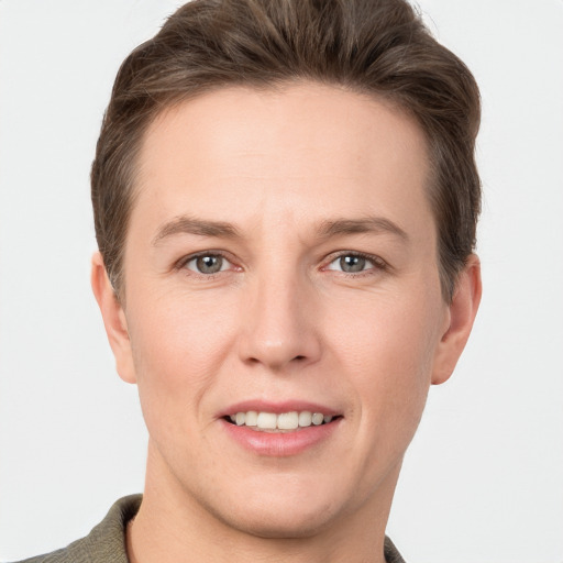 Joyful white young-adult female with short  brown hair and grey eyes