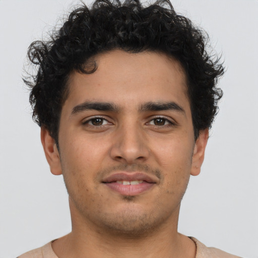 Joyful latino young-adult male with short  brown hair and brown eyes