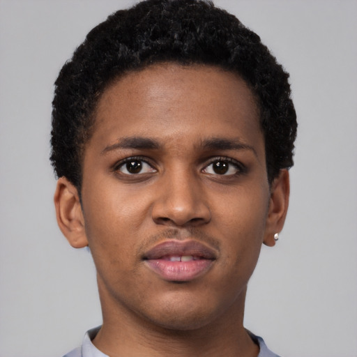 Joyful black young-adult male with short  brown hair and brown eyes