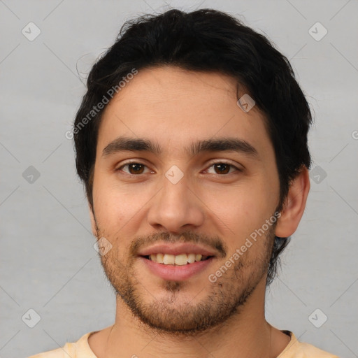 Joyful white young-adult male with short  black hair and brown eyes