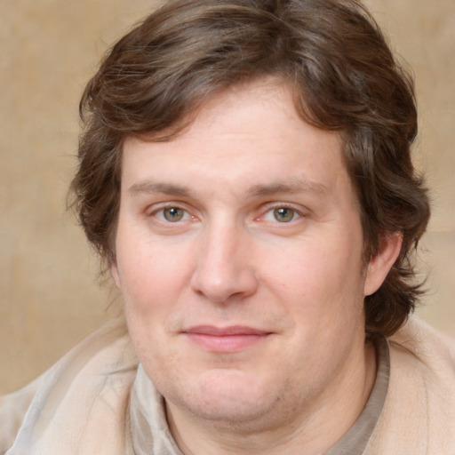 Joyful white adult male with medium  brown hair and brown eyes