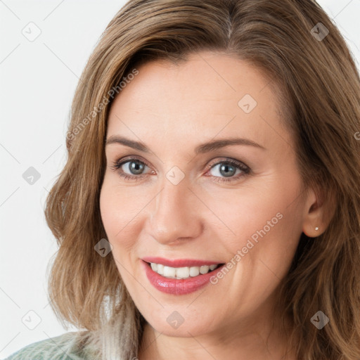 Joyful white young-adult female with long  brown hair and green eyes