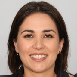 Joyful white young-adult female with medium  brown hair and brown eyes