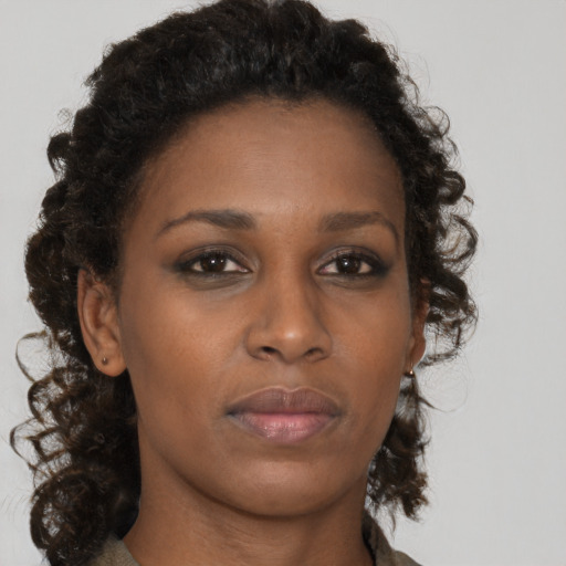 Neutral black young-adult female with long  brown hair and brown eyes