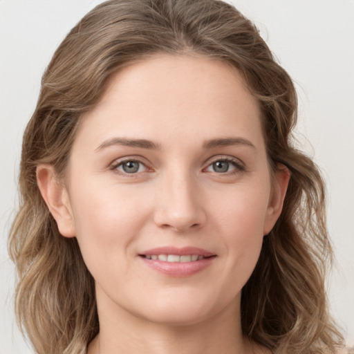 Joyful white young-adult female with long  brown hair and grey eyes