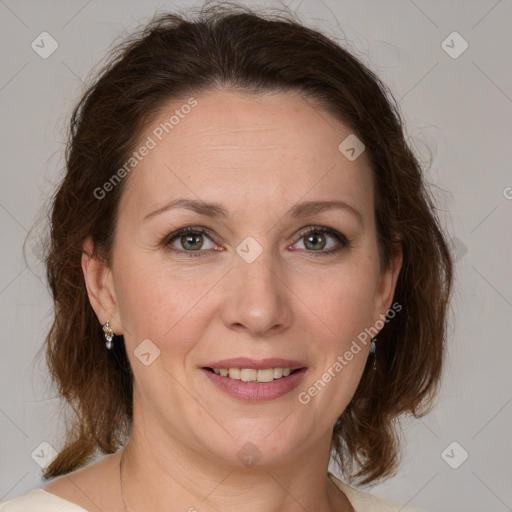 Joyful white adult female with medium  brown hair and grey eyes