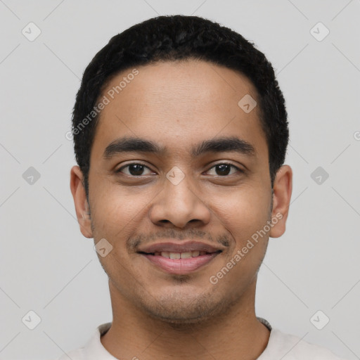 Joyful latino young-adult male with short  black hair and brown eyes