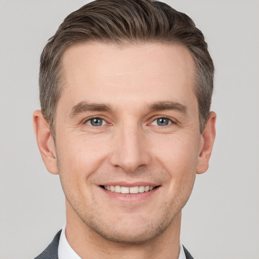 Joyful white young-adult male with short  brown hair and brown eyes